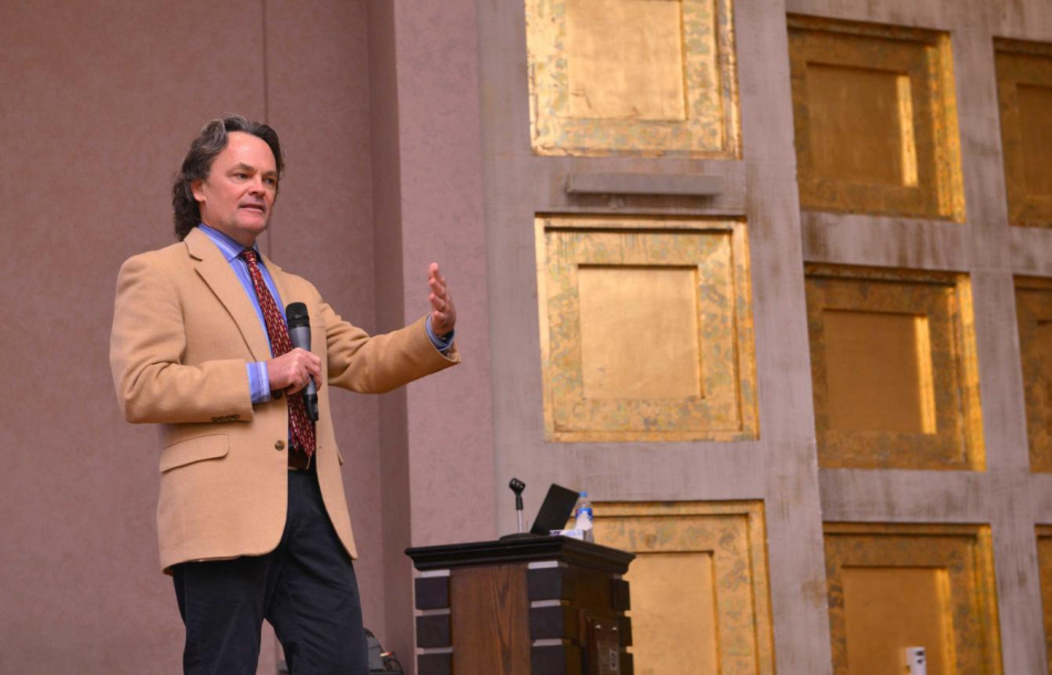 Dan Tormey giving a speech at the front of a lecture hall