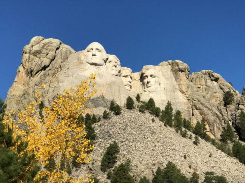 a group of stone faces carved into Mount Rushmore National Memorial
