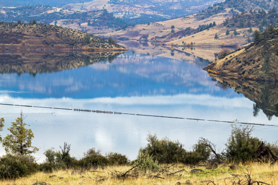 a lake with hills and trees