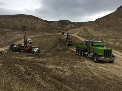 a group of trucks in a dirt field