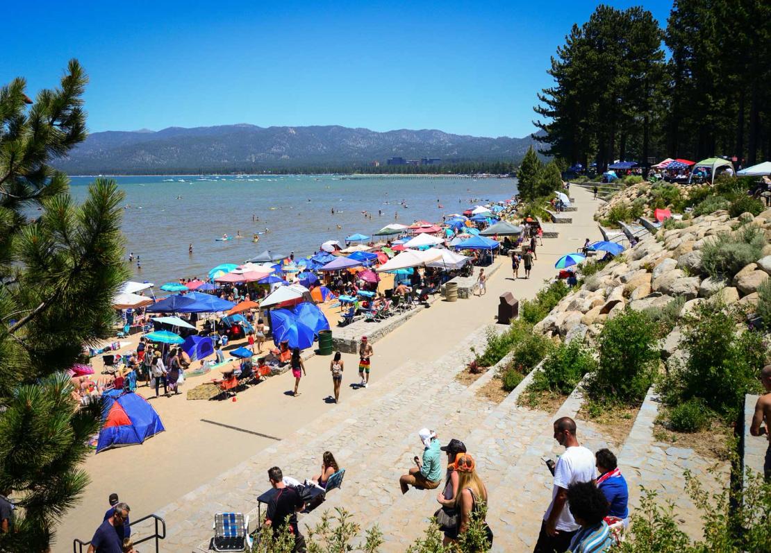 a beach with umbrellas and people on it