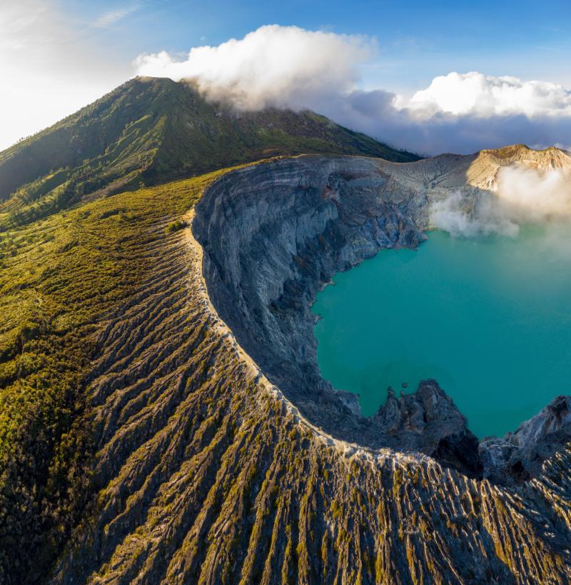 a mountain with a lake and a mountain in the background