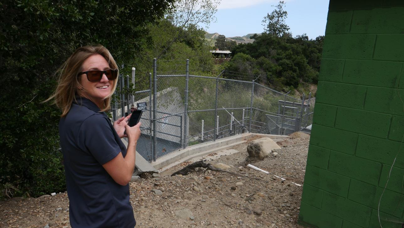 a person taking a picture of a fence