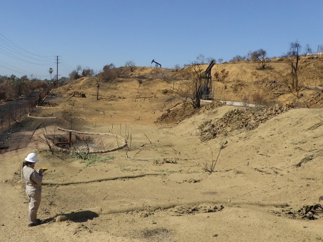 a dirt hill with a pump jack
