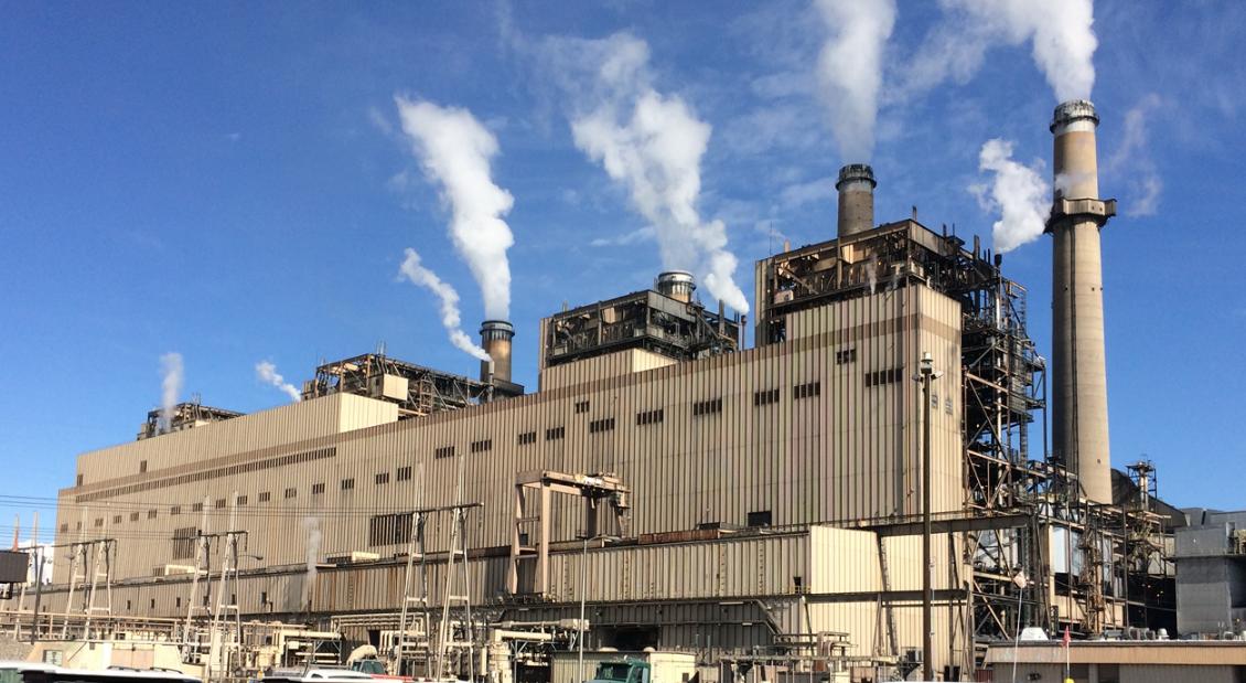 a large factory with smoke coming out of it