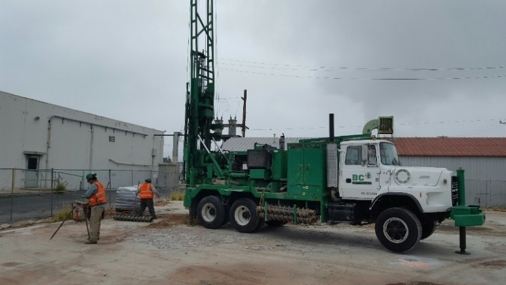 a green truck with a crane