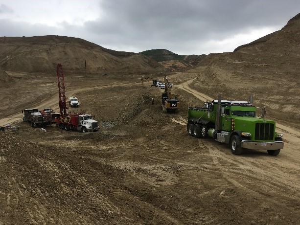 a group of trucks in a dirt field